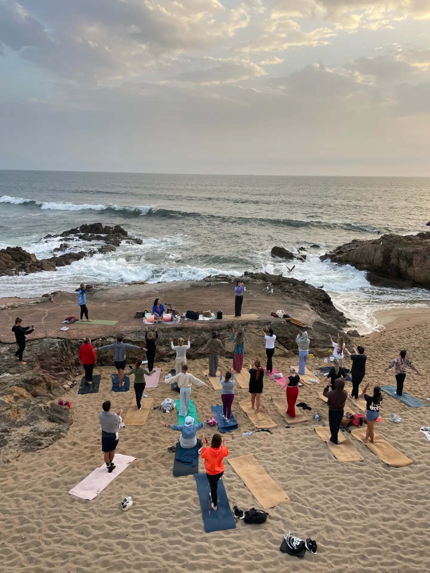 Clase de yoga en grupo en la playa